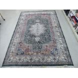 A Persian silk and woollen rug, profusely decorated with floral,