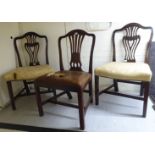 A pair of early 19thC mahogany framed dining chairs with moulded, pierced and carved backs,