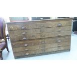 An early 20thC oak plan chest, the six drawers converted to two sections,
