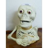 A painted cast iron skeleton money box 7''h BSR