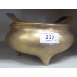 A late 19th/20thC Chinese cast bronze censer of squat, bulbous form with opposing, open lip handles,