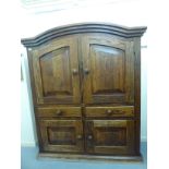 An early 20thC French panelled oak cupboard, having a round arched top,