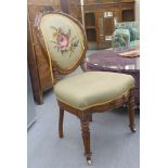 An early 20thC French inspired walnut framed bedroom chair with a fabric upholstered back and seat,