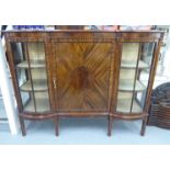 A mid 20thC mahogany breakfront display cabinet with a central panelled door,