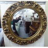 A 20thC Regency design mirror with a convex plate,