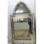 A 20thC Italian design mirror with a multi-panelled border in relief 45'' x 25'' BSR