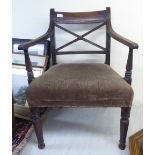 A Regency reed carved mahogany framed elbow chair with a crossover splat and an upholstered seat,