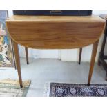 A modern reproduction of a late 19thC satinwood finished and string inlaid Pembroke table with