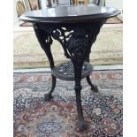 A late Victorian cast iron public house table, the turned wooden top raised on a triform base,