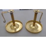 A pair of Arts & Crafts rivetted brass chambersticks,
