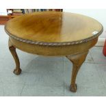 A 1930s mahogany coffee table, raised on cabriole legs,