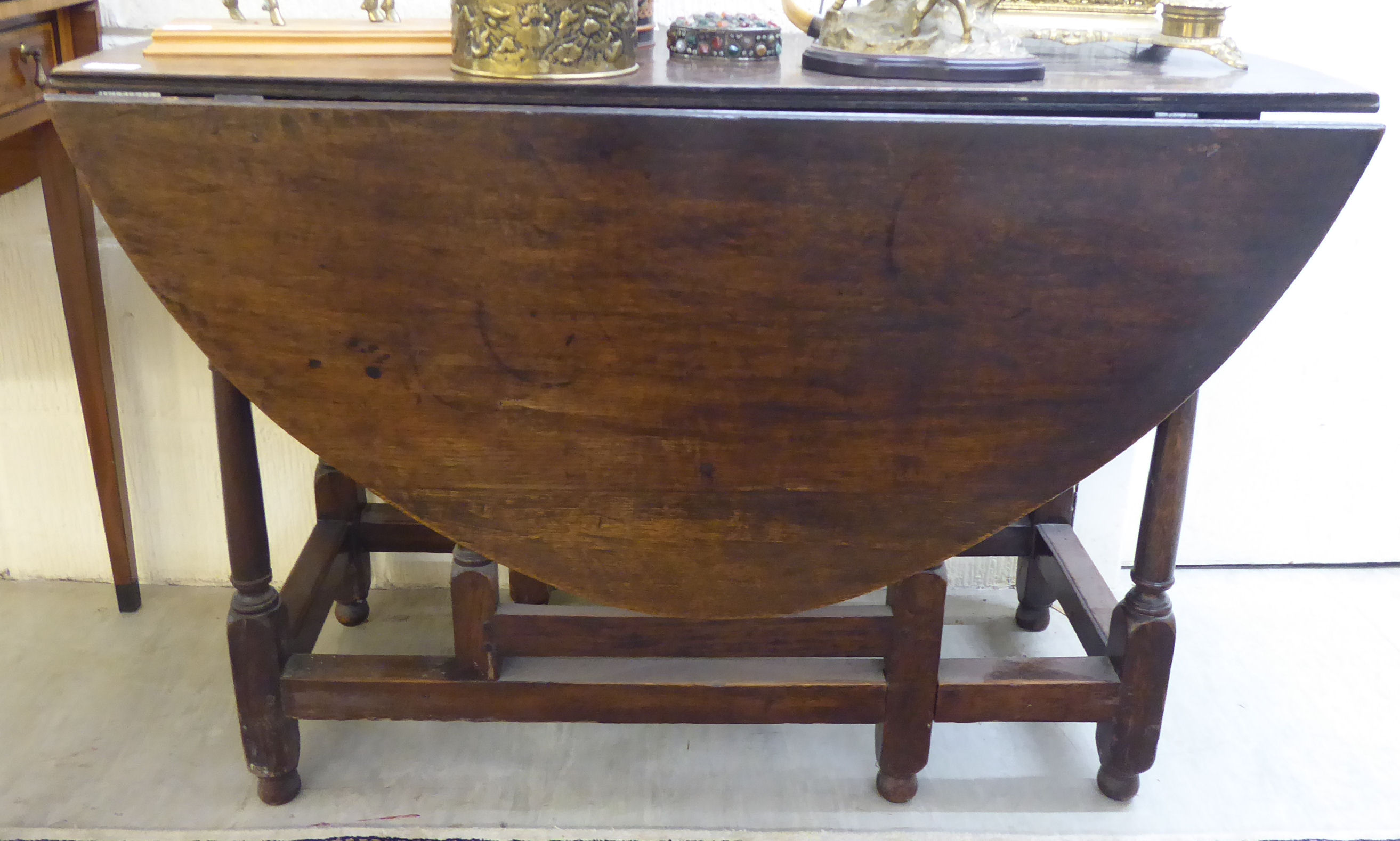A 19thC country made oak gateleg table with an oval top,