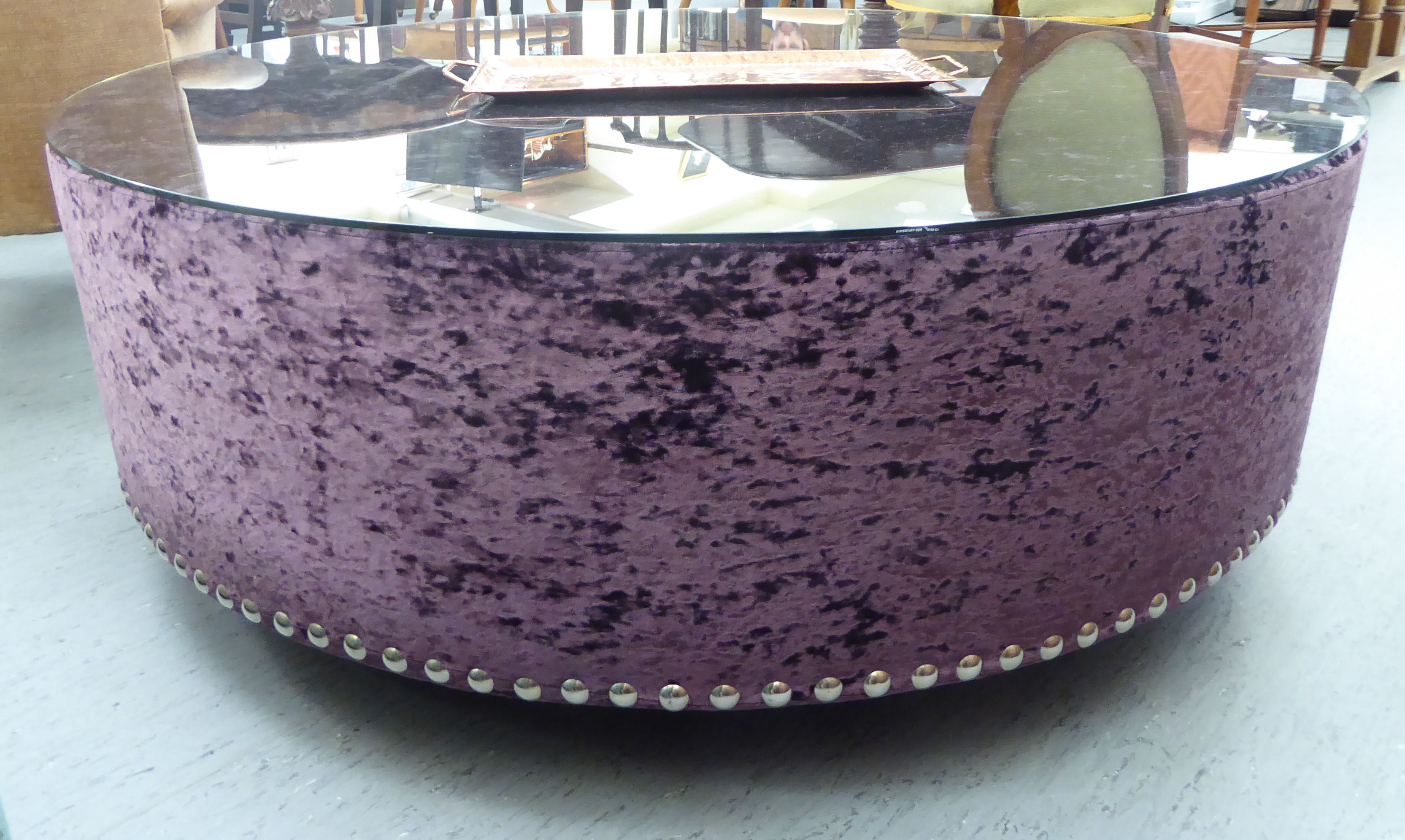 A crushed velvet covered coffee table 16''h 47''dia CA