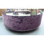 A crushed velvet covered coffee table 16''h 47''dia CA