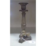 An early/mid 20thC cast brass 'antique' design single socket candlestick, on a fluted,