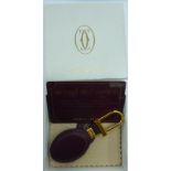 A Cartier hide keyring boxed with an identification card 290E 101120 11