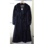 A possibly Blackglama full-length, black ranch mink coat with cuffs and a collar approx.