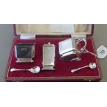 A three piece silver condiments set of chamfered box design comprising a salt cellar,