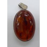 A white metal mounted amber coloured pendant 11