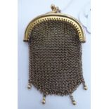 A late Victorian 9ct gold framed chainmail sovereign purse with a crossover clasp and pendant ring