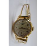 A lady's Longines gold plated round cased bracelet wristwatch, faced by an Arabic and baton dial,