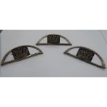 A set of three novelty menu holders, fashioned as horse stirrups, each surmounted by a crown,