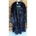 A full-length black mink coat with waist detail and collar approx.