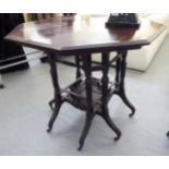 An early 20thC mahogany centre table, the octagonal top raised on ring turned supports,