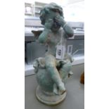 A Verdigris patinated cast iron garden ornament, a cherub sitting on a ball 12.