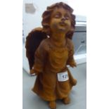 A cast iron statue, a cherub blowing a kiss 9.