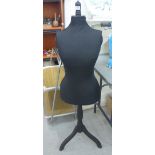 A modern black fabric covered mannequin,