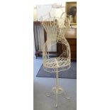 A decoratively woven, cream coloured steel wire framed mannequin,