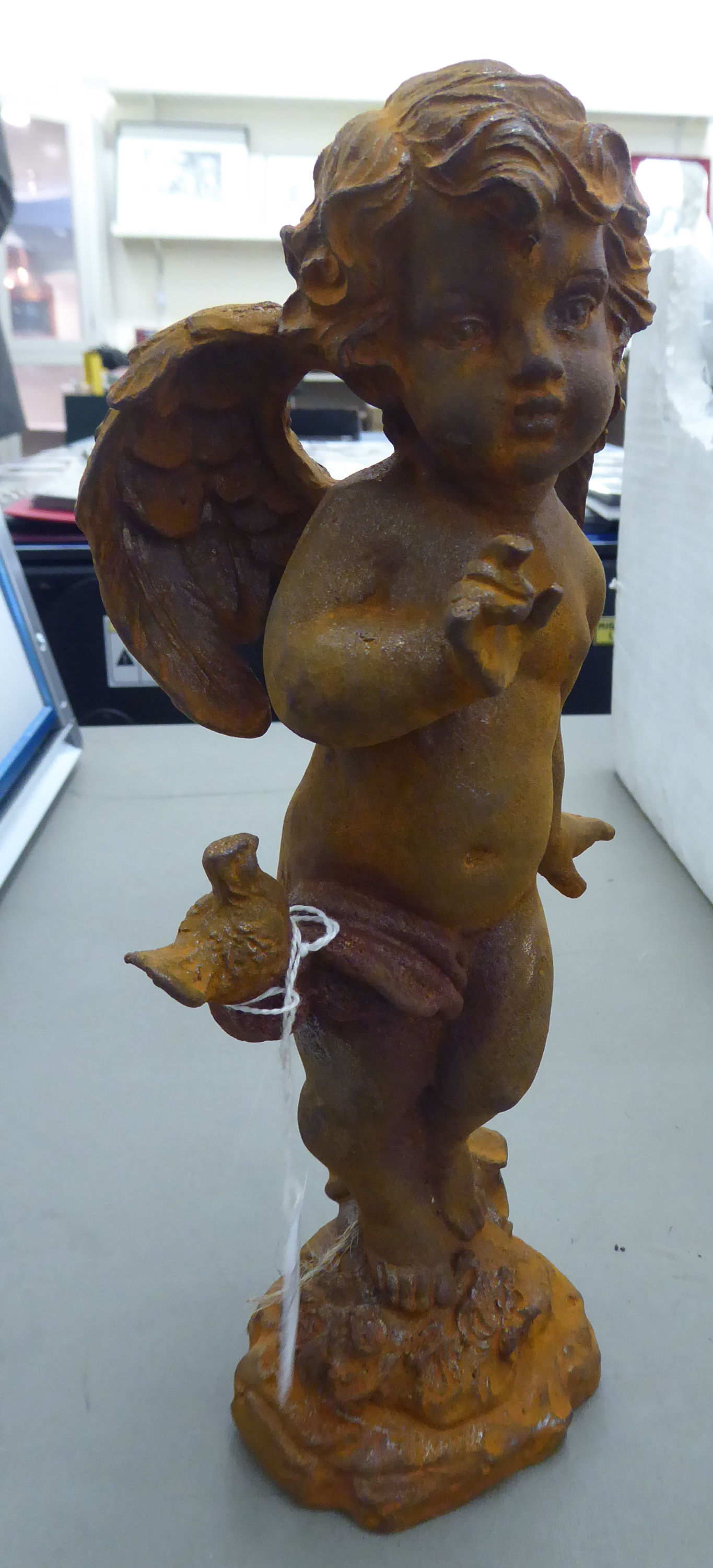 A cast iron statue, a cherub,