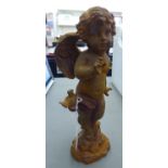 A cast iron statue, a cherub,