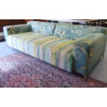 A modern patterned fabric upholstered three person low, level back settee,