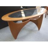 A G-Plan Astro teak oval coffee table with an inset plate glass top,