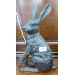 A patinated cast metal garden ornament, a hare 14.