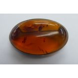 A white metal framed amber coloured brooch 11