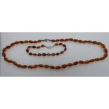 An amber coloured graduated bead necklace and matching bracelet 11