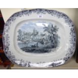 A late Victorian earthenware meat plate, decorated with a scene of a castle,