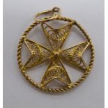 A yellow metal filigreeworked pendant,