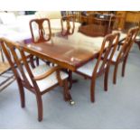 A modern mahogany finished twin pedestal dining table, raised on splayed,
