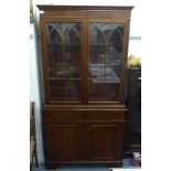 A modern Georgian style mahogany finished Georgian style cabinet bookcase with a dentil moulded