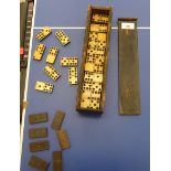 A set of early 20thC bone and ebonised dominos boxed OS3