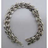 A silver foliate design multi-link bracelet stamped 925 11