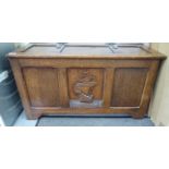 A 1930s stained oak coffer with straight sides and a hinged lid,