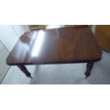 A late Victorian mahogany wind-out dining table, the top with round corners, raised on bulbous,