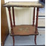 An early 20thC painted walnut two tier etagere with a low brass galleried bordered,