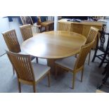 A modern light oak dining suite,