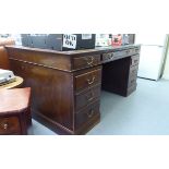 An early/mid 20thC mahogany nine drawer twin pedestal desk,